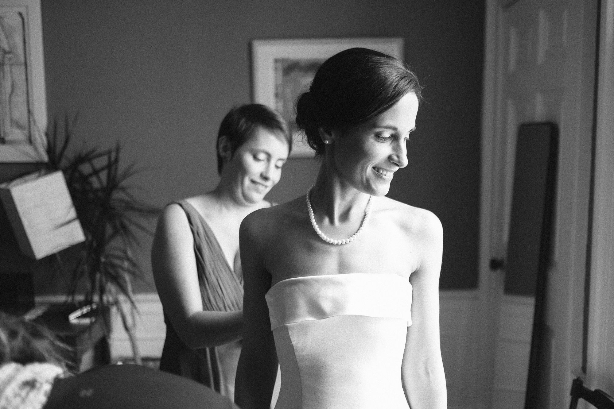 Black and white picture of bride getting ready for wedding