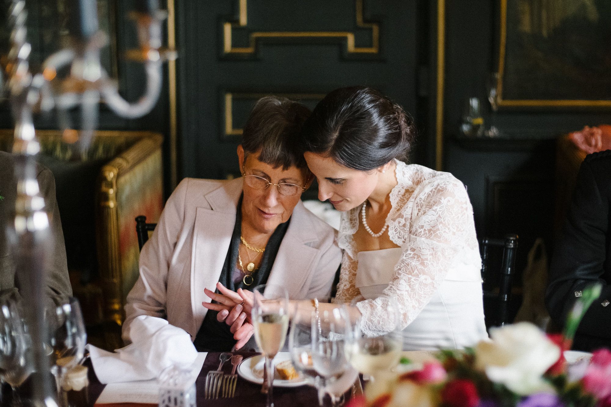 Bride with her mother are looking at wedding rings