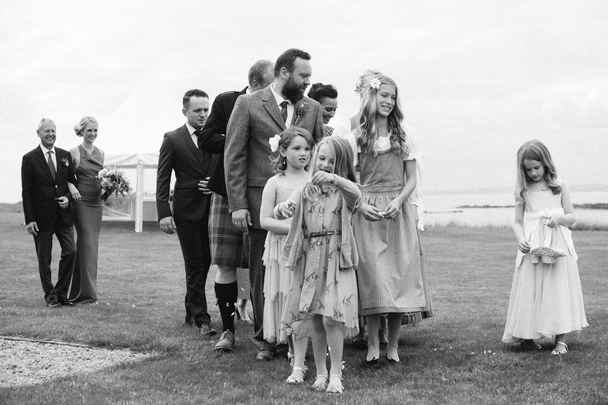 Wedding guests walking to the seaside ceremony at Archerfield House
