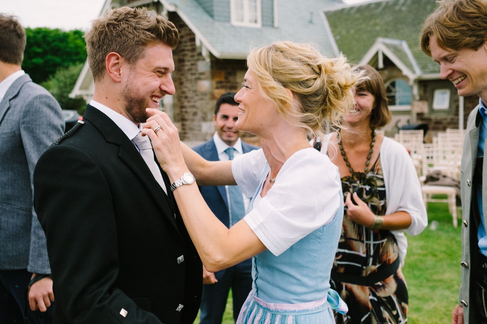 Happy groom with relatives after wedding ceremony