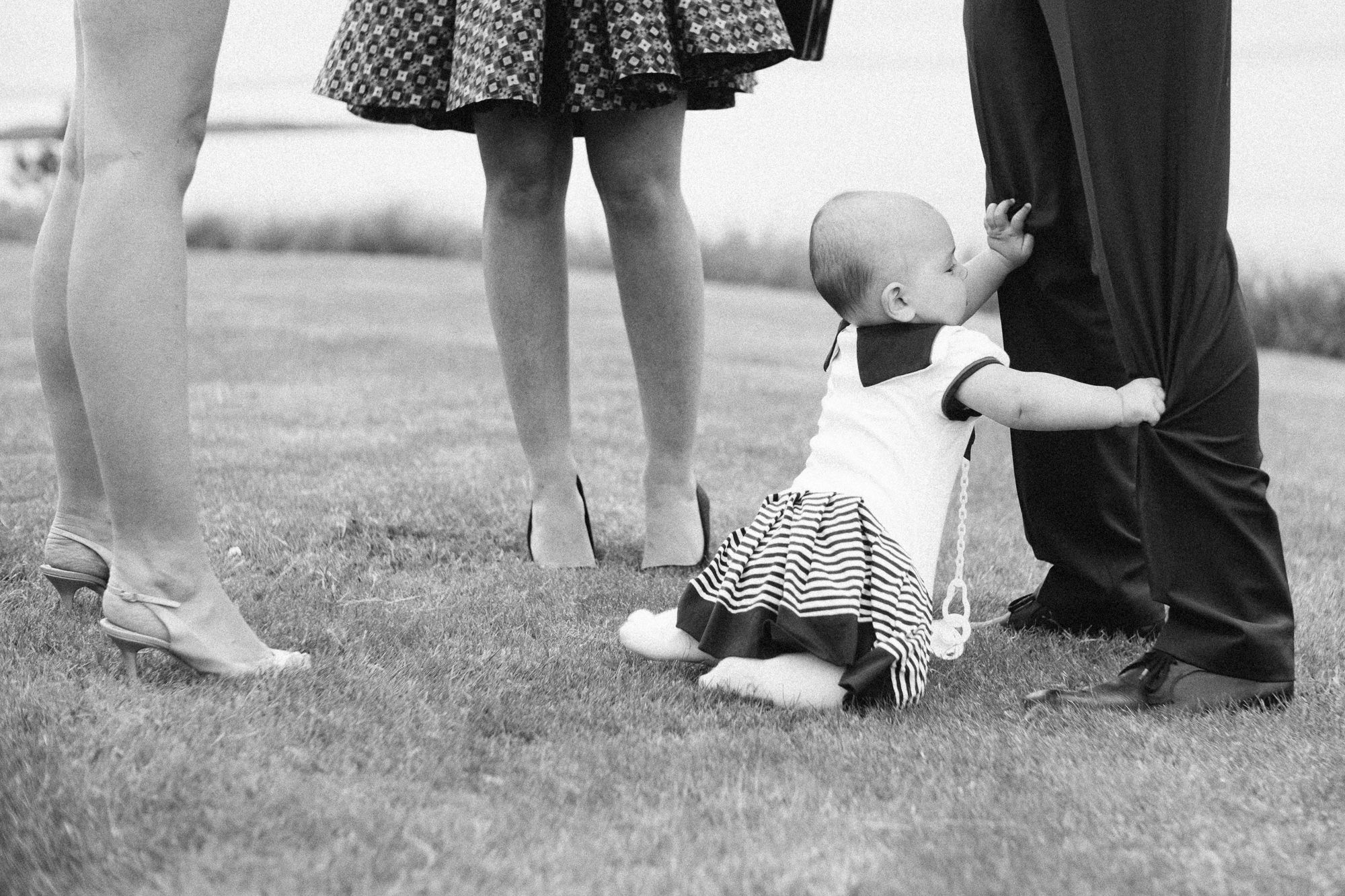 Child playing while parents are chatting on the grounds at seaside