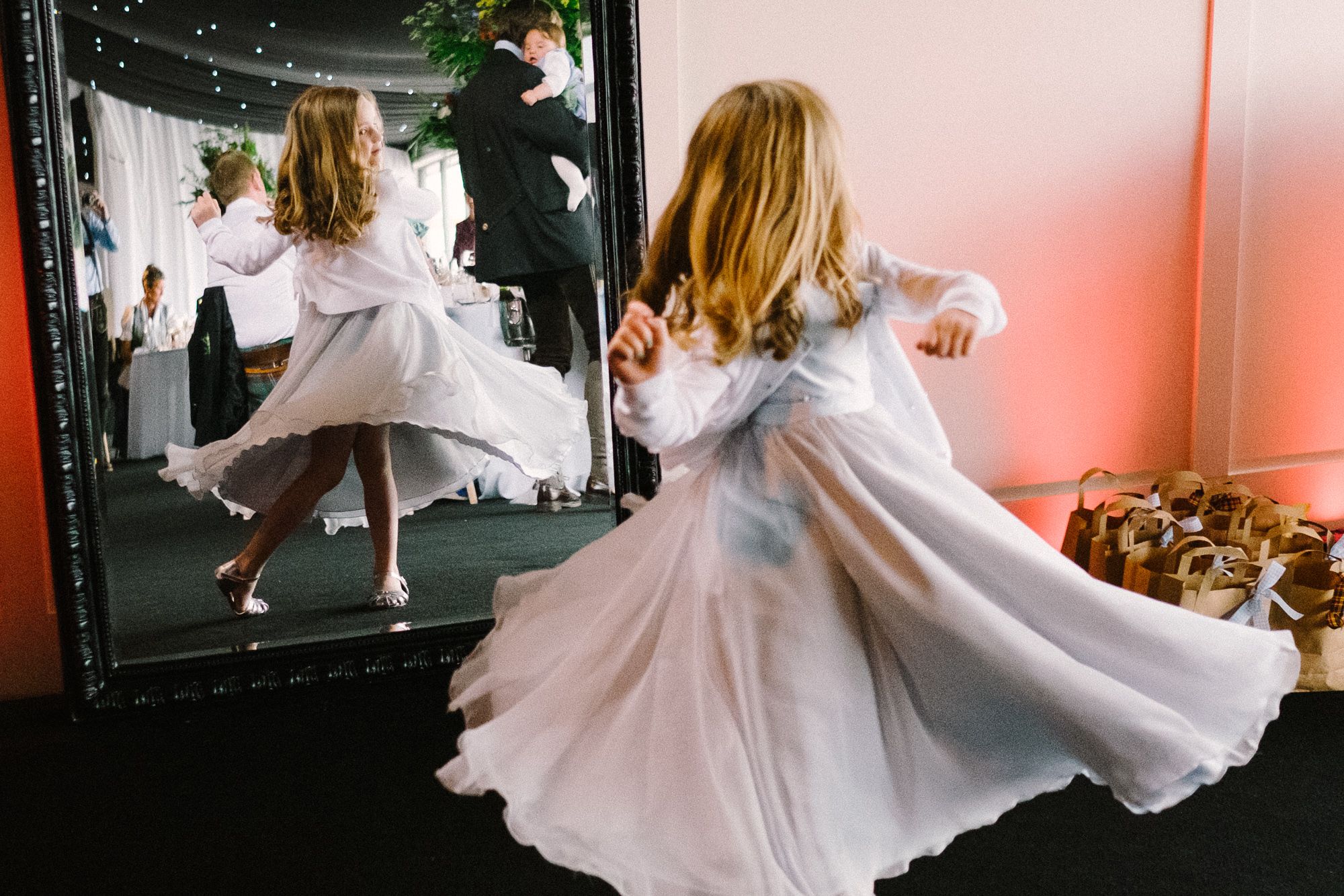 Little girl dancing in front of mirror