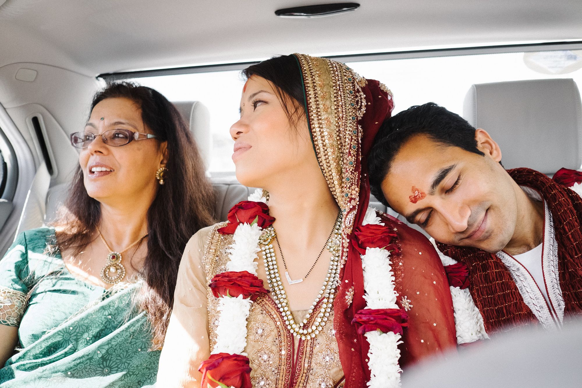 Bride and groom in car after Hindu ceremony at Bhaktivedanta Manor temple London