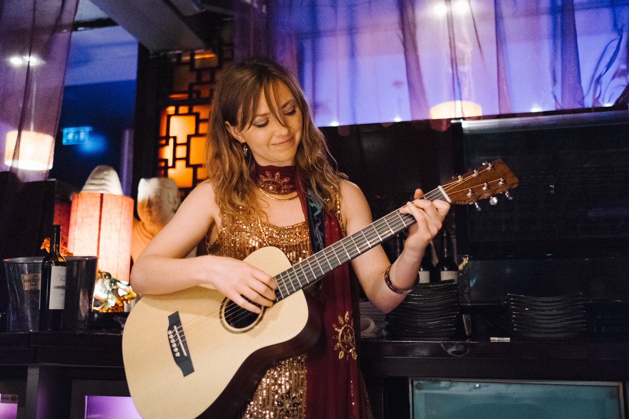 Wedding guest playing guitar at dinner