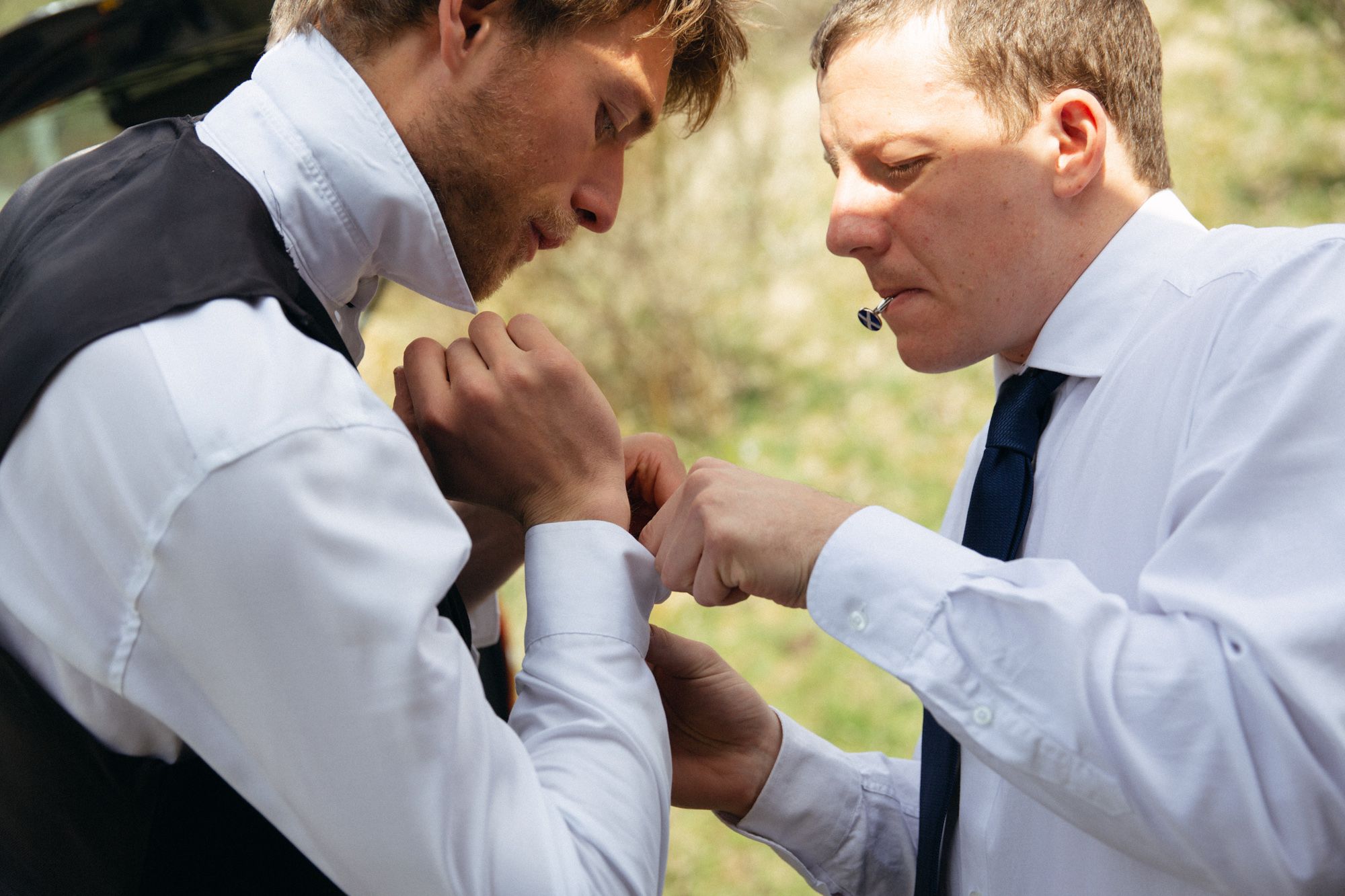 Groom getting ready for rustic rural wedding