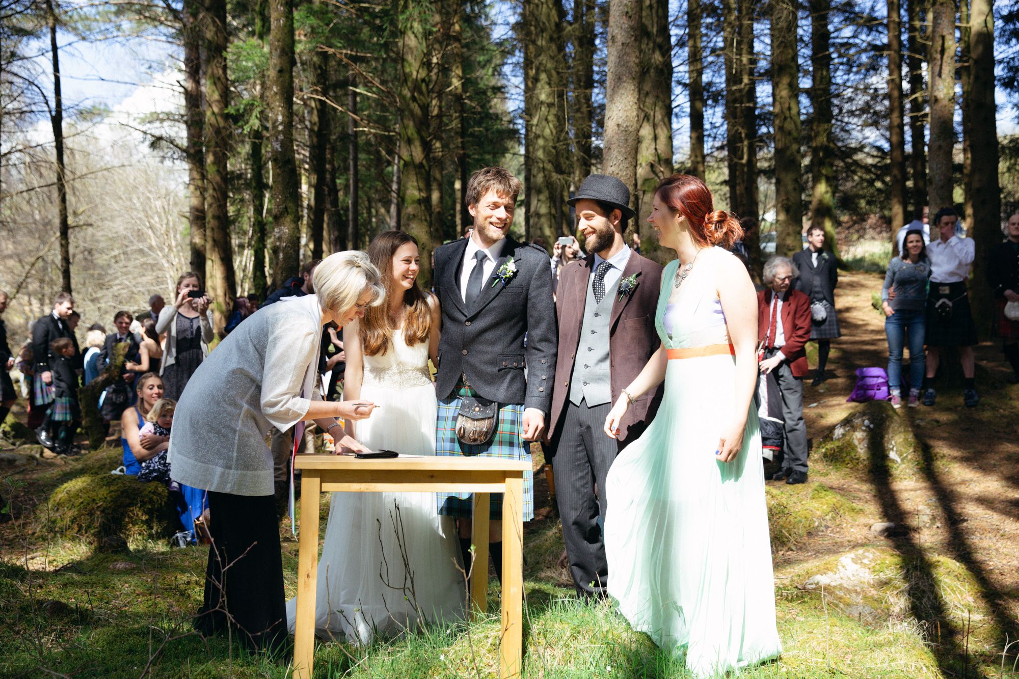 Wedding couple and witnesses at rustic forest wedding Scotland