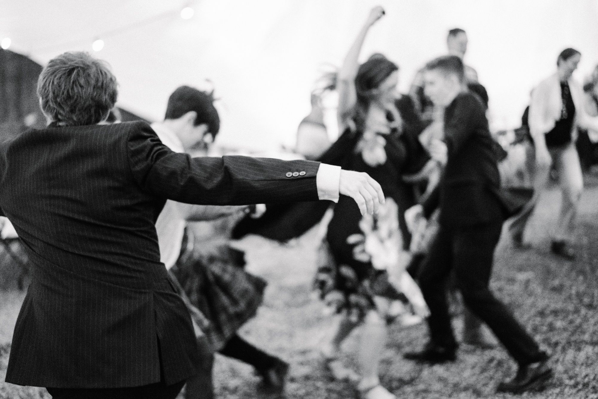 Rustic rural spring wedding guests dancing