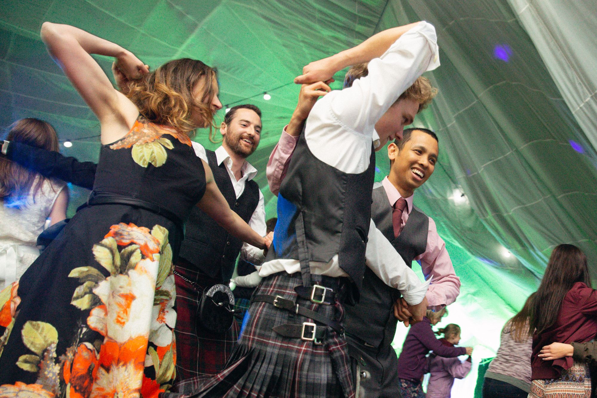 Rustic rural spring wedding guests dancing