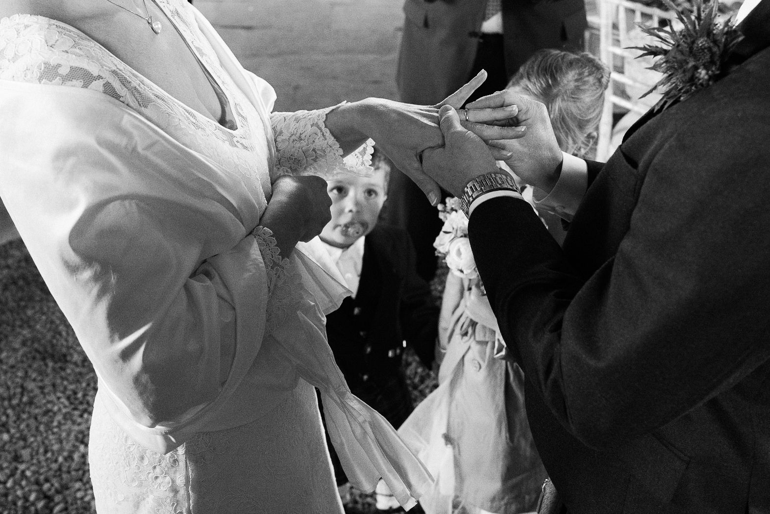 Couples's son watching the rings during wedding ceremony