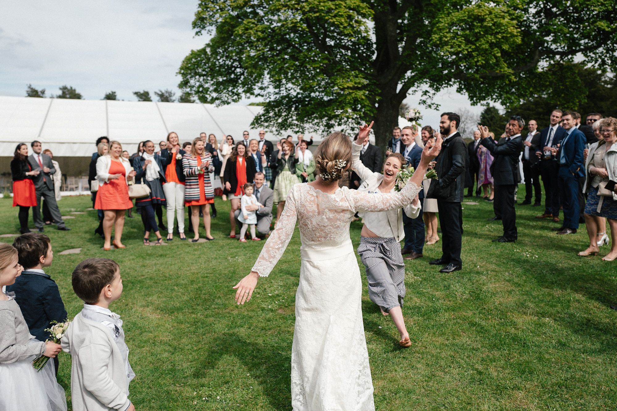 Tossing the bouquet at Dunglass Estate wedding