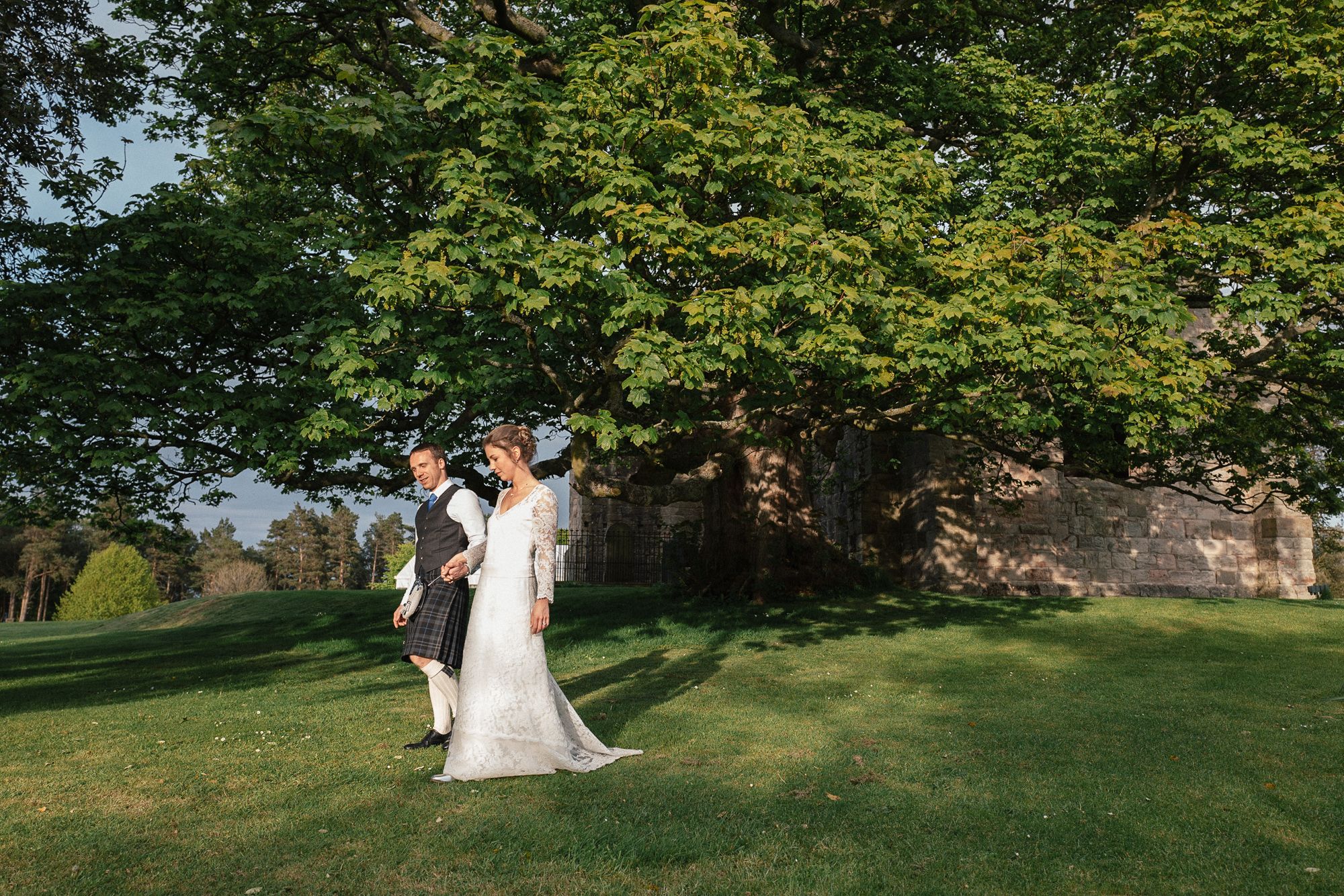 French couple walk on the grounds of Dunglass Estate