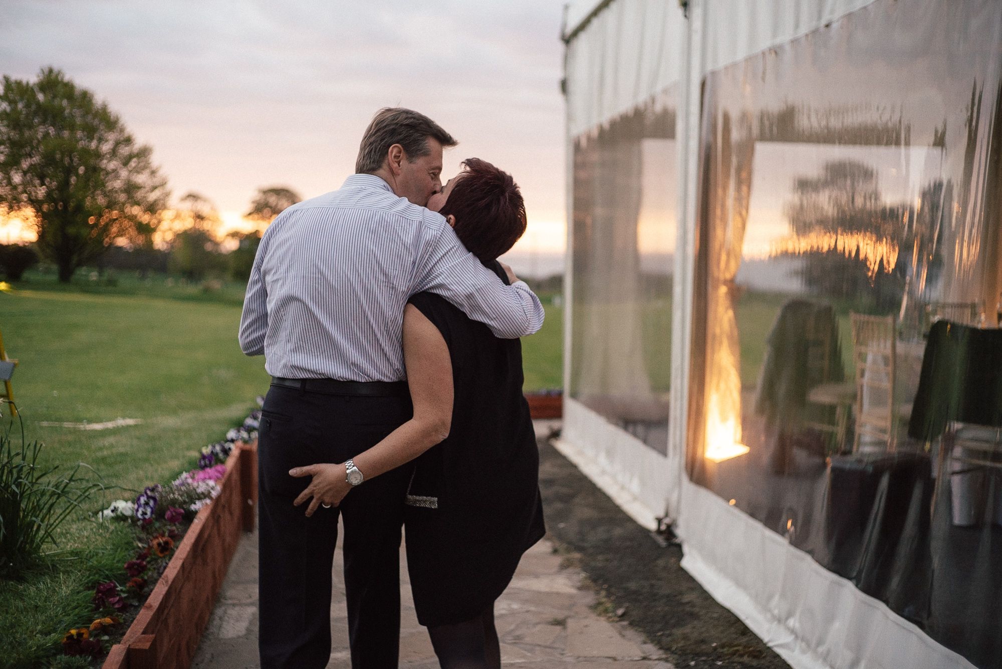 Romantic moment of a couple at wedding marquee