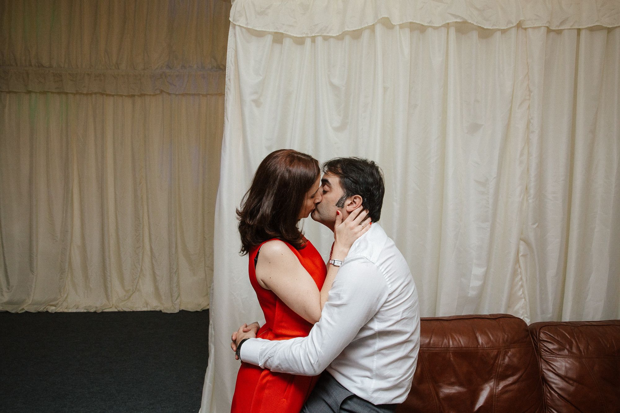 Wedding guests kissing