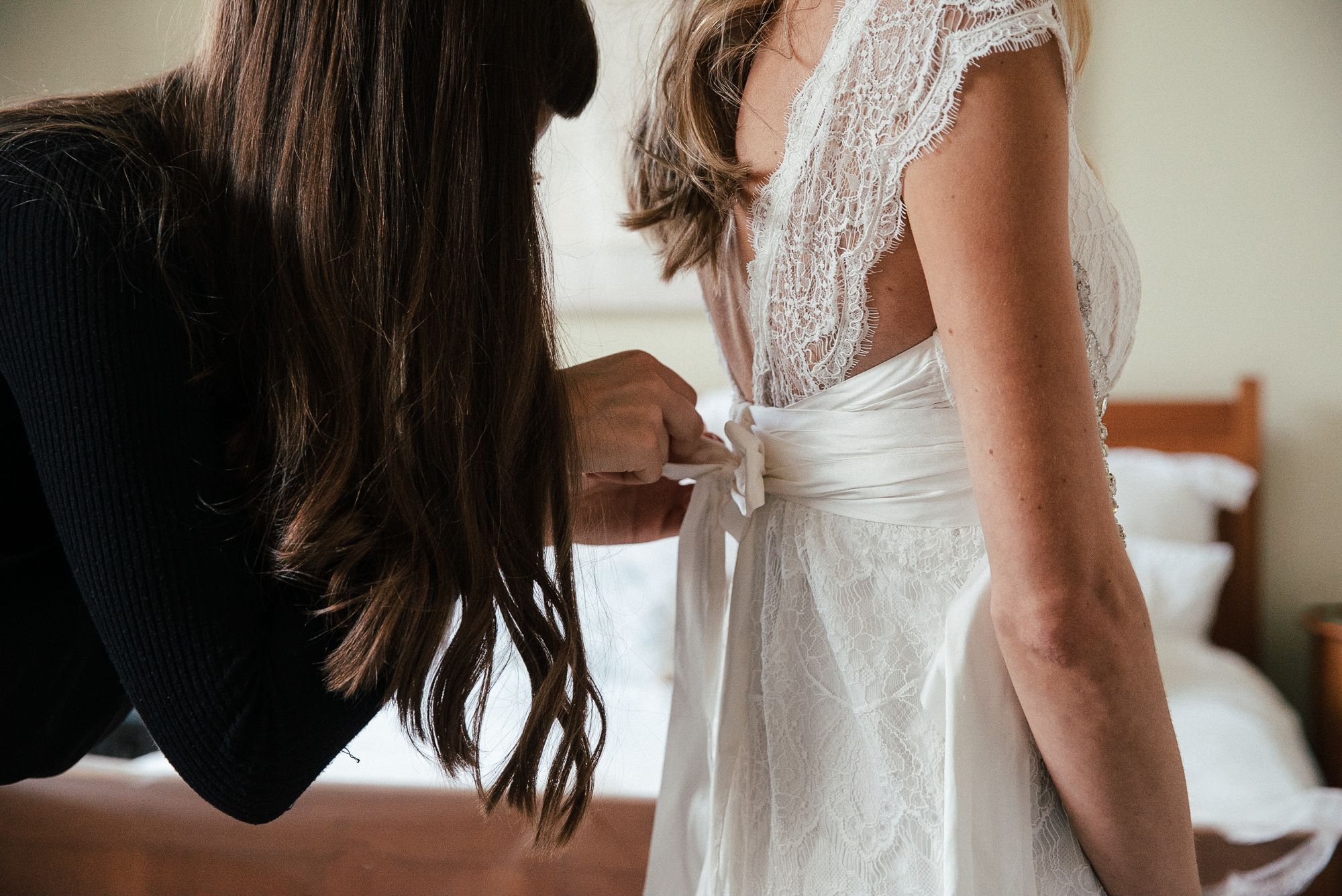 bridal preparations bride getting ready fitting dress