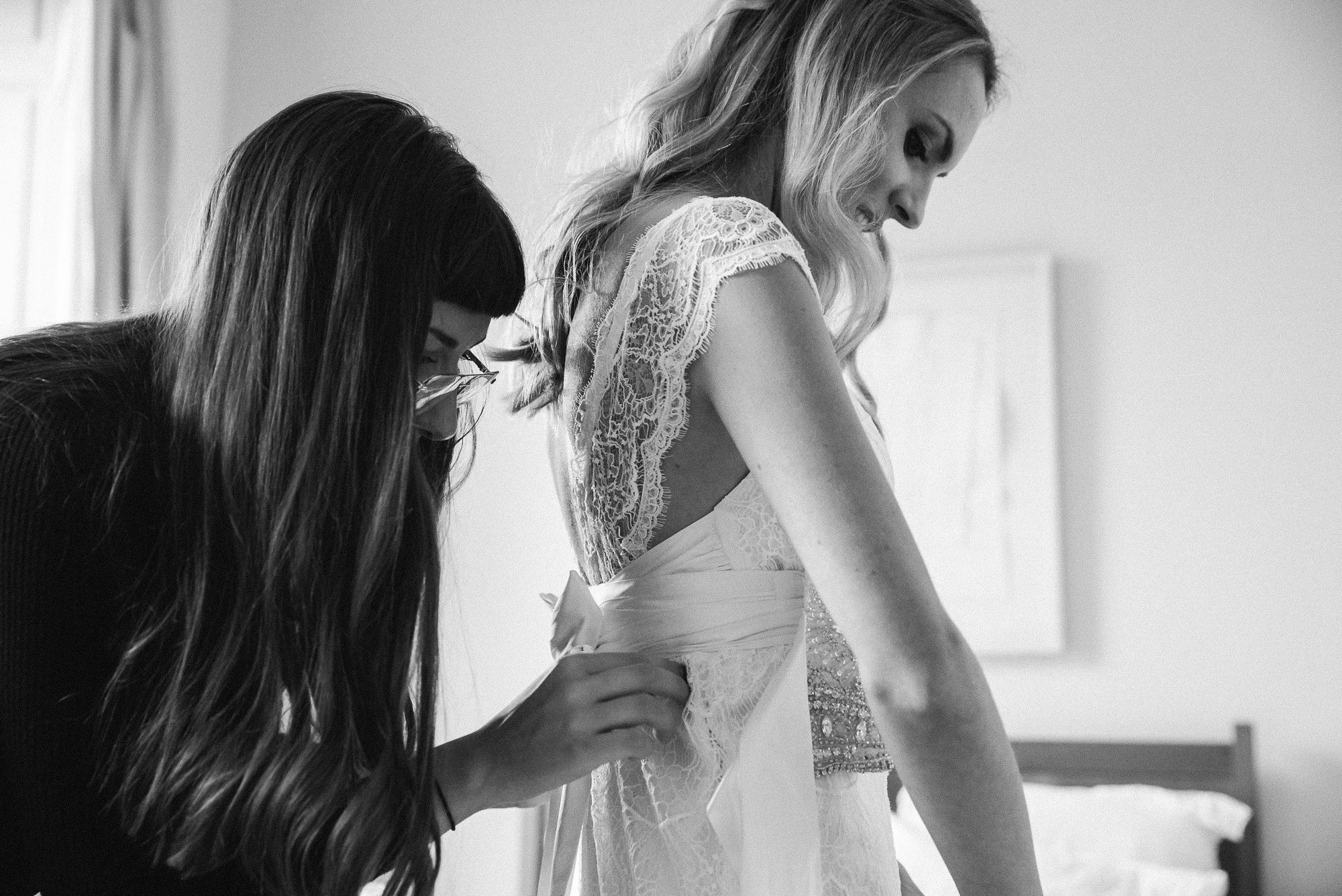 bride getting ready fitting dress